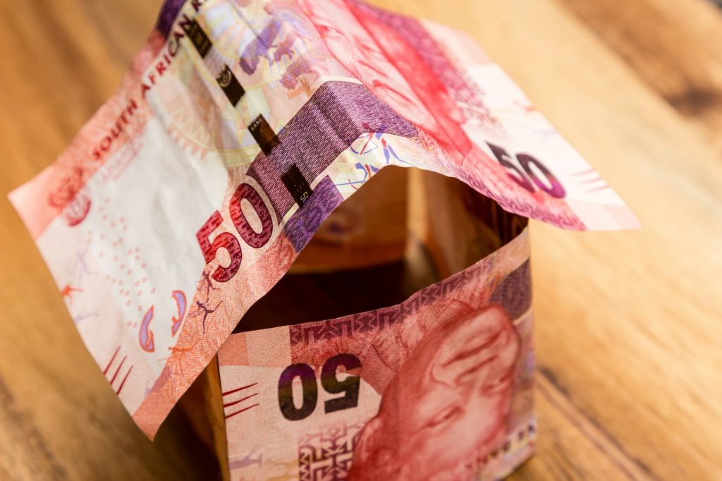 High angle shot of some South African rand bills on a wooden surface