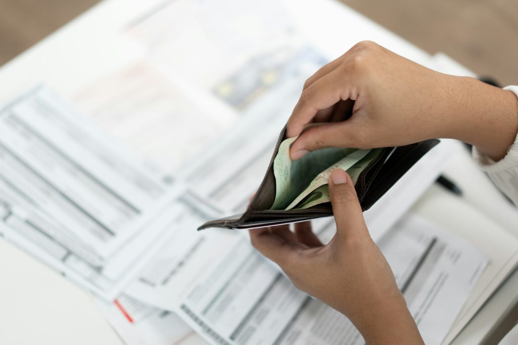 Worried unemployment woman open empty wallet on payday